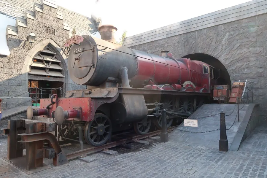 The Hogwarts Express steam locomotive, numbered 5972, stationed at Hogsmeade Station in Universal Studios
