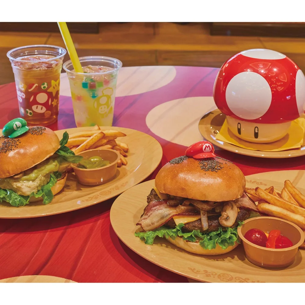 Super Nintendo World themed burgers with Mario and Luigi hats and mushroom soup.