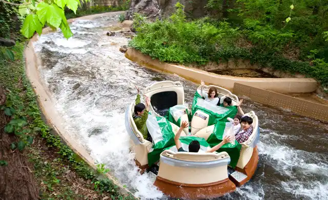 Visitors riding a circular raft down rushing rapids on the Amazon Express water ride at Everland Theme Park.